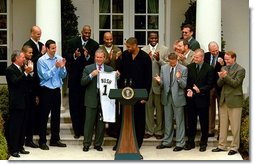 President George W. Bush holds up a jersey presented to him during a ceremony welcoming the 2003 NBA Champion San Antonio Spurs in The Rose Garden Tuesday, Oct. 14, 2003.  White House photo by Paul Morse