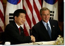 President George W. Bush and South Korean President Roh Moo-Hyun meet for a working breakfast in Bangkok, Thailand, Oct. 20, 2003.  White House photo by Paul Morse