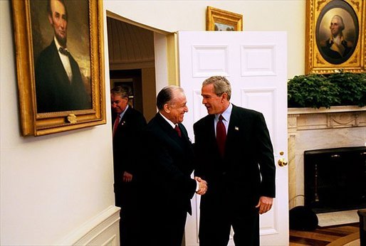 President George W. Bush welcomes Romanian President Ion Iliescu to the Oval Office Tuesday, Oct. 28, 2003. White House photo by Tina Hager.