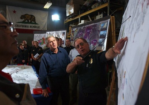 President George W. Bush receives a briefing and update on the wildfires from Division Chief John Hawkins of the Califrornia Department of Forestry in El Cajon, Calif., Tuesday, Nov. 4, 2003. White House photo by Eric Draper.
