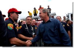 President George W. Bush greets firefighters after speaking in El Cajon, Calif., Tuesday, Nov. 4, 2003  White House photo by Eric Draper