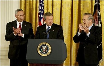President George W. Bush delivers remarks at the signing of The Emergency Supplemental Appropriations Act for Defense and for The Reconstruction of Iraq and Afghanistan in the East Room Thursday, Nov. 6, 2003. Pictured with the President are Secretary of State Colin Powell, left, and Defense Secretary Donald Rumsfeld. White House photo by Susan Sterner
