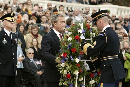Honoring those who died in service to America, President George W. Bush lays a wreath at the Tomb of the Unknowns in Arlington Cemetery on Veterans Day Nov. 11, 2003. After the wreath was placed, "Taps" was played and a moment of silence was observed. White House photo by Paul Morse.