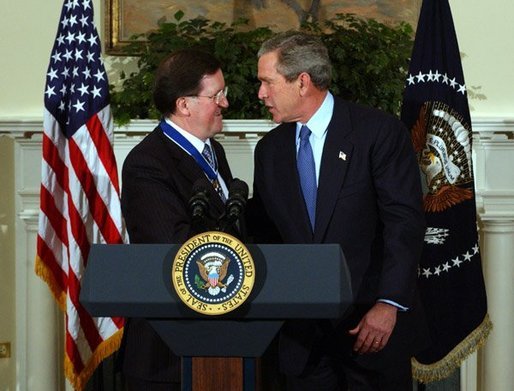 President George W. Bush congratulates NATO Secretary General Lord George Robertson after awarding him the Presidential Medal of Freedom during a ceremony in the Roosevelt Room Wednesday, Nov. 12, 2003. White House photo by Tina Hager.