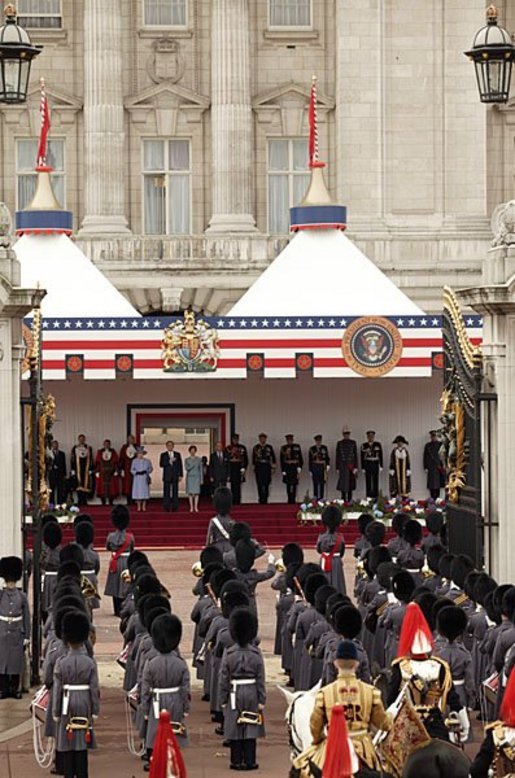 President George W. Bush and Laura Bush listen to the playing of America's national anthem during an official welcome ceremony at Buckingham Palace in London, Wednesday, Nov. 19, 2003. Standing with them are Her Majesty Queen Elizabeth and Prince Philip, Duke of Edinburgh. The President and Mrs. Bush last visited Buckingham Palace July of 2001. White House photo by Paul Morse.