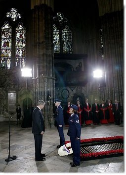 President George W. Bush bows his head in silence as a wreath is laid at the Tomb of the Unknown Warrior at Westminster Abbey in London Thursday, Nov. 20, 2003.  White House photo by Eric Draper