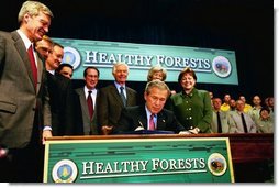 President George W. Bush signs the Healthy Forests Restoration Act of 2003 at the Department of Agriculture Wednesday, December 3, 2003.  White House photo by Tina Hager