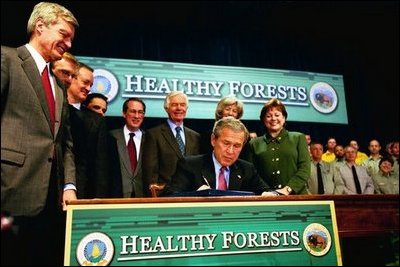 President George W. Bush signs the Healthy Forests Restoration Act of 2003 at the Department of Agriculture Wednesday, December 3, 2003. White House photo by Tina Hager. White House photo by Tina Hager