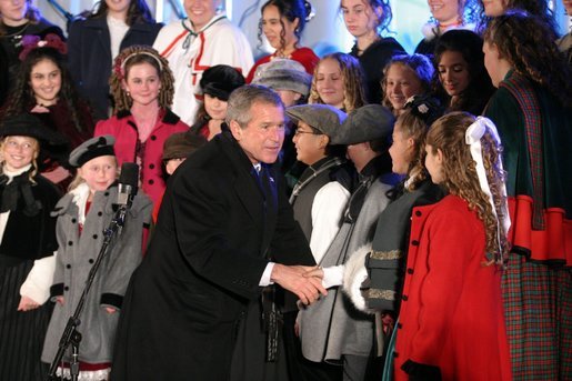 President George W. Bush greets the Voena Children's Choir at the Pageant of Peace after lighting the National Christmas Tree at the Ellipse in Washington DC on Thursday December 4, 2003. White House photo by Paul Morse.