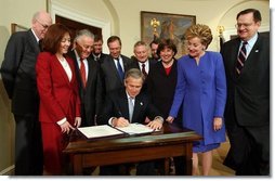 President George W. Bush signs H.R. 2622, the Fair and Accurate Credit Transactions Act of 2003, into law during a ceremony in the Roosevelt Room Thursday, December 4, 2003.  White House photo by Tina Hager