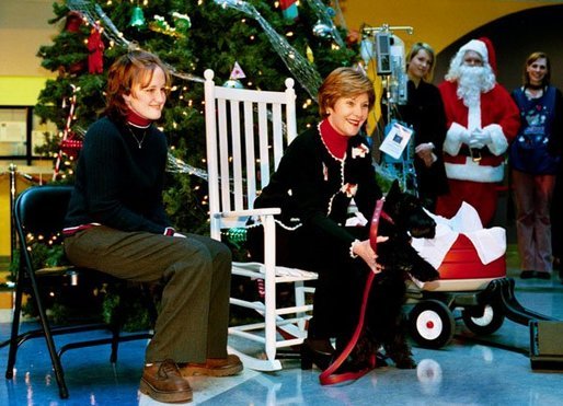 Laura Bush introduces her Scottish Terrier Barney Bush at the Children's National Medical Center during the annual Christmas program and visit to the hospital Friday, Dec. 12, 2003. Mrs. Bush is accompanied by Stephanie Chapman. White House photo by Susan Sterner