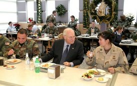 During lunch with troops from McChord Air Force Base and Fort Lewis, Vice President Dick Cheney talks with Capt. Lyn Marm, right, and Senior Airman Jose L. Negron, left, at McChord Air Force Base, Wash., Dec. 22, 2003. Prior to lunch, Vice President Cheney addressed the troops and presented the Bronze Star to Maj. Brian Robinson and The Purple Heart to Spc. Justin L. Anderson and Sgt. Johnie L. Smith. Vice President Cheney presented Air Medals to Capt. Paul Sontein, Capt. Anne R. Lueck, 1st Lt. Andrew D. Oiland, Tech. Sgt. James S. Alexander and Staff Sgt. Eric M. Olsen.  White House photo by David Bohrer