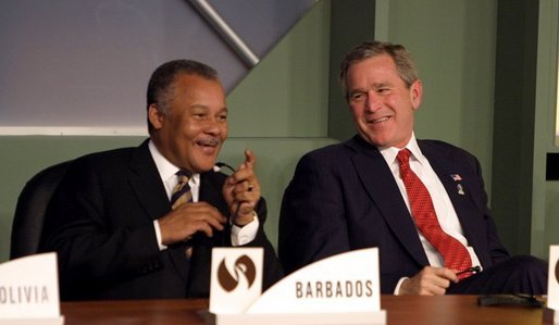 President George W. Bush talks with the Prime Minister Owen Arthur of Barbados during the inaugural ceremony of the Special Summit of the Americas in Monterrey, Mexico, Jan. 12, 2004. White House photo by Paul Morse.