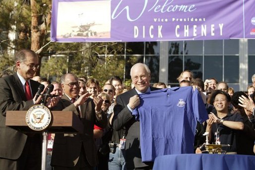 After congratulating NASA staff on the successful landing of the robotic rover Spirit on Mars, Vice President Dick Cheney holds up a shirt bearing the Spirit emblem at the Jet Propulsion Laboratory in Pasedena, Calif., Jan. 14, 2004. White House photo by David Bohrer