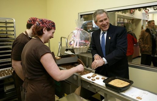 President George W. Bush helps make chocolate candy while visiting Swan Chocolates in Merrimack, N.H., Jan. 29, 2004. White House photo by Paul Morse