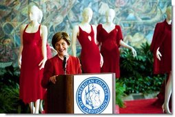 Laura Bush visits the Red Dress Project Exhibit and delivers remarks to the media after accepting the 2004 Colleges of Cardiology's Honorary Fellowship in New Orleans, Louisiana. " If we can encourage women to take charge of their health and the health of their families, we can do the same for heart disease. With the many risk factors for heart disease, a woman's greatest risk is ignorance. So I encourage all of you to pull out your favorite red tie or red dress and tell every woman and physician that you know that heart disease doesn't care what you wear." Monday, March 8, 2004.  White House photo by Tina Hager