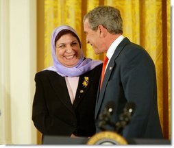 President George W. Bush greets Dr. Raja Habib Khuzai of the Iraqi Governing Council after delivering remarks on Women’s Human Rights in the East Room of the White House Fridy, March 12, 2004.  White House photo by Paul Morse