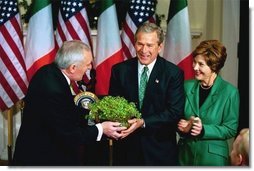 President George W. Bush and Laura Bush receive a bowl of Shamrock from Ireland's Prime Minister Bertie Ahren during the annual ceremony celebrating St. Patrick's Day in the Roosevelt Room Wednesday, March 17, 2004.  White House photo by Tina Hager