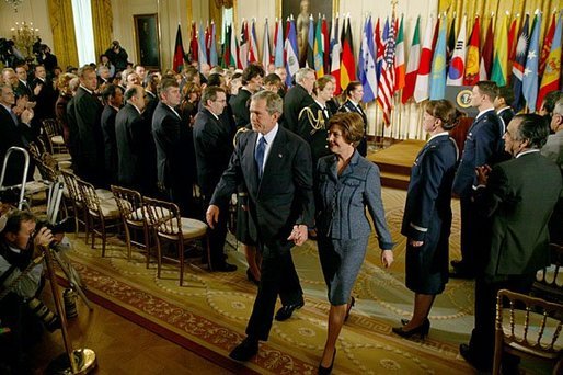 President George W. Bush and Laura Bush exit the East Room following the President's remarks commemorating the one-year anniversary of operation Iraqi Freedom and the efforts of his administration and 91 nations to ensure peace and stability in Iraq, Afghanistan and the Greater Middle East Friday, March 19, 2004. White House photo by Susan Sterner.