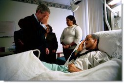 After presenting him The Purple Heart, President George W. Bush salutes U.S. Army Staff Sergeant Santiago Frias of Bronx, N.Y., at Walter Reed Army Medical Center in Washington, D.C., Friday, March 19, 2004. Sgt. Frias was injured while serving in Operation Iraqi Freedom. Also pictured is Sgt. Frias' mother, Cristina DeJesus, left, and his wife, Nejil.  White House photo by Eric Draper