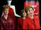 During a trip to Chicago, Mrs. Bush discusses the Red Dress Project Tuesday, March 23, 2004. Behind Mrs. Bush are dresses designed by American fashion designers which are touring the country to raise awareness of heart disease in women. White House photo by Tina Hager