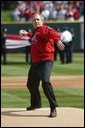 President George W. Bush throws out the first pitch during the St. Louis Cardinals’ season opener against the Milwaukee Brewers at Busch Stadium in St. Louis, Mo., Monday, April 5, 2004. White House photo by Eric Draper