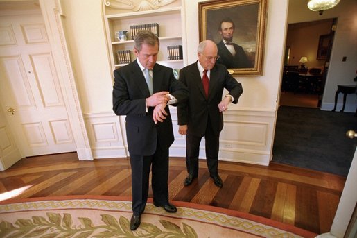 President and Vice President both checking their watches in the Oval Office before the President departed the White House for an event. White House photo by Eric Draper.