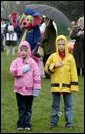 A couple of soaked Easter Egg Roll enthusiasts say the Pledge of Allegiance during the opening ceremonies of the 2004 White House Easter Egg Roll on the South Lawn Monday, April 12, 2004. Despite rain and cold weather, families came out for a morning of Easter eggs and storybook readings. White House photo by Paul Morse.