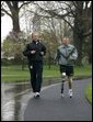 President George W. Bush runs with U.S. Army Staff Sergeant Michael McNaughton, of Denham Springs, La., on the South Lawn of the White House Wednesday, April 14, 2004. The two met January 17, 2003, at Walter Reed Army Medical Center, where SSgt. McNaughton was recovering from wounds sustained in Afghanistan. The President then wished SSgt. McNaughton a speedy recovery so that they might run together in the future. White House photo by Eric Draper.