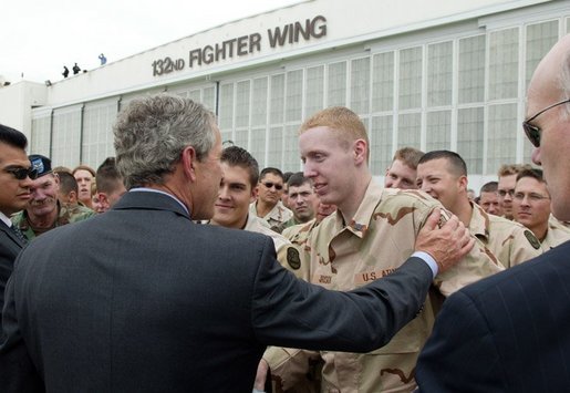 President George W. Bush talks with Robert Jackson of the 186th Military Police Company at the Iowa Air National Guard Base in Des Moines, Iowa, Thursday, April 15, 2004. Jackson was injured while serving in Iraq. White House photo by Paul Morse