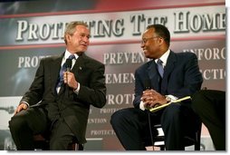 President George W. Bush thanks Larry Thompson, former Deputy Attorney General of the United States, for his service during a conversation on the USA Patriot Act in Buffalo, N.Y., Tuesday, April 20, 2004. "The Patriot Act needs to be renewed and the Patriot Act needs to be enhanced," said the President of the act that is due to expire next year.  White House photo by Eric Draper