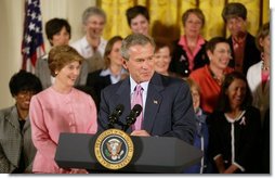 President George W. Bush gives remarks with First Lady Mrs. Laura Bush at a reception for the National Race for the Cure in the East Room of the White House on April 21, 2004.  White House photo by Paul Morse