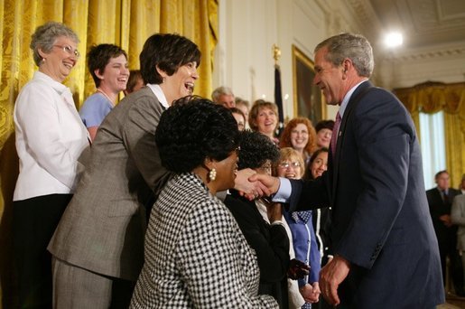 President George W. Bush greets breast cancer survivors at a reception for the National Race for the Cure in the East Room of the White House on April 21, 2004. White House photo by Paul Morse