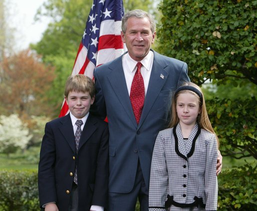 President George W. Bush congratulates siblings Alexander, 10, and Sara Reid, 8, of Central Elementary School of Belmont, Calif., on receiving the President’s Environmental Award in the East Garden April 22, 2004. White House photo by Susan Sterner.