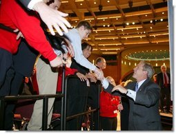 President George W. Bush greets the crowd after giving remarks to the American Associations of Community Colleges annual convention in Minneapolis, Minn., Monday, April 26, 2004.  White House photo by Paul Morse