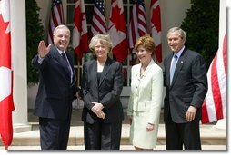 President George W. Bush and Mrs. Laura Bush with Canadian Prime Minister Paul Martin and his wife Sheila Martin after responding to questions from the press corps in the Rose Garden of the White House on April 30, 2004.  White House photo by Paul Morse