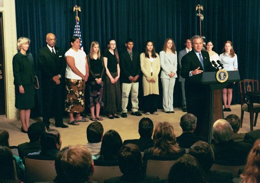President George W. Bush delivers remarks about the Indian Education Executive Order at the Eisenhower Executive Office Building Friday, April 30, 2004. With the President are Secretary of the Interior Gale Norton and Secretary of Education Rod Paige and students from the Sault Ste Marie, Michigan, High School and Chiloquin, Oregon, High School Native American Science Bowl Teams. White House photo by Tina Hager