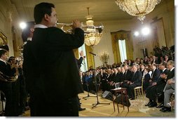 President George W. Bush listens to Banda El Recodo during a White House ceremony honoring Cinco de Mayo in the East room Wednesday, May 5, 2004. Mexican recording artists Marco Antonio Solis and Jimena also performed during the event.   White House photo by Paul Morse