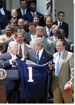 President George W. Bush receives a jersey from New England Patriots owner Bob Kraft and coach Bill Belichick during a photo opportunity with the Super Bowl champions in the Rose Garden on May 10, 2004.  White House photo by Paul Morse