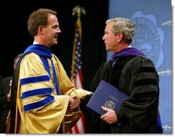 President George W. Bush is congratulated upon receiving an honorary doctorate degree during the commencement ceremonies for Concordia University near Milwaukee, Wis., Friday, May 14, 2004.  White House photo by Paul Morse