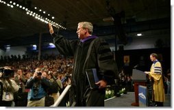 President George W. Bush waves to the audience after being awarded an honorary doctorate degree from Dr. Patrick Ferry at the commencement ceremonies for Concordia University near Milwaukee, Wis., Friday, May 14, 2004.  White House photo by Paul Morse