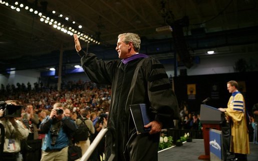 President George W. Bush waves to the audience after being awarded an honorary doctorate degree from Dr. Patrick Ferry at the commencement ceremonies for Concordia University near Milwaukee, Wis., Friday, May 14, 2004. White House photo by Paul Morse.