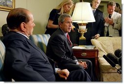 President George W. Bush and Prime Minister Silvio Berlusconi of Italy address the media in the Oval Office Wednesday, May 19, 2004.  White House photo by Joyce Naltchayan