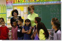 Laura Bush visits with students from Ms. Valdez's first grade reading class at Reginald Chavez Elementary School in Albuquerque, N.M., Thursday, May 20, 2004. In her remarks, Mrs. Bush discussed the Summer Reader's Achievement Program, "And the goal of it is to encourage children in kindergarten through eighth grade to read over the summer, which will mitigate the loss in reading skills that research shows takes place in students, especially low-income students who leave school in the spring and don't pick up a book all summer and then come back in the fall and they really have to start over again on a lot of their reading skills."  White House photo by Tina Hager