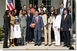 President George W. Bush takes a team photo with the Detroit Shock, the 2003 WNBA champions in the Rose Garden on May 24, 2004.  White House photo by Paul Morse
