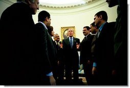 President George W. Bush talks with several Iraqis who receive medical care in the United States during a meeting in the Oval Office Tuesday, May 25, 2004. The Iraqi citizens each had one hand cut off in Iraq during Saddam's rule. "They are examples of the brutality of the tyrant," said President Bush. "These men had hands restored because of the generosity and love of an American citizen. And I am so proud to welcome them to the Oval Office."  White House photo by Eric Draper