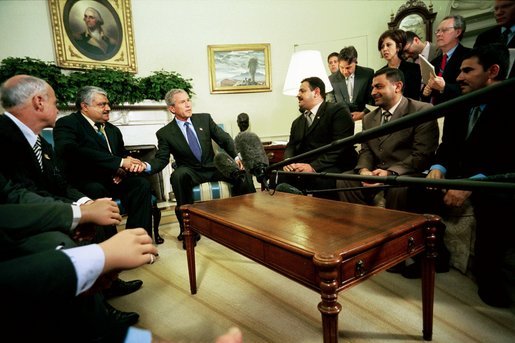 President George W. Bush talks with the press during an Oval Office meeting with several Iraqis who receive medical care in the United States Tuesday, May 25, 2004. "I'm honored to shake the hand of a brave Iraqi citizen who had his hand cut off by Saddam Hussein," said the President. "I'm with six other Iraqi citizens, as well, who suffered the same fate. They are examples of the brutality of the tyrant." White House photo by Eric Draper