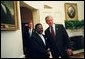 President George W. Bush welcomes President Omar Bongo Ondimba of Gabon to the Oval Office Wednesday, May 26, 2004. White House photo by Eric Draper.