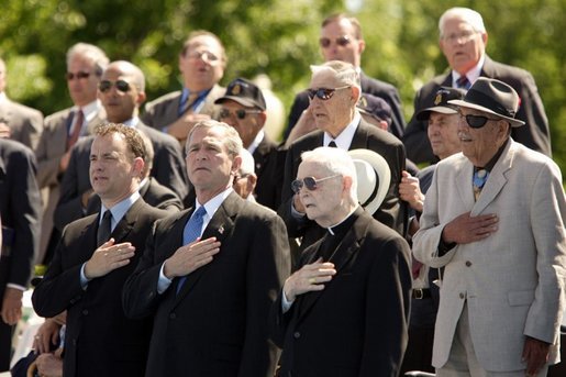 President George W. Bush sings the National Anthem with World War II veterans during the dedication of at the National World War II memorial on the Mall in Washington, DC on May 30, 2004. White House photo by Paul Morse