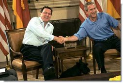 President George W. Bush and German Chancellor Gerhard Schroeder shake hands during their bilateral meeting at the G-8 Summit in Sea Island, Ga., Tuesday, June 8, 2004. Barney, is seen in foreground.  White House photo by Eric Draper